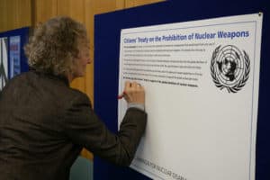 Jenny Jones signing Citizens' Treaty on the Prohibition of Nuclear Weapons
