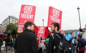 People hold placards that say "jobs not Trident"