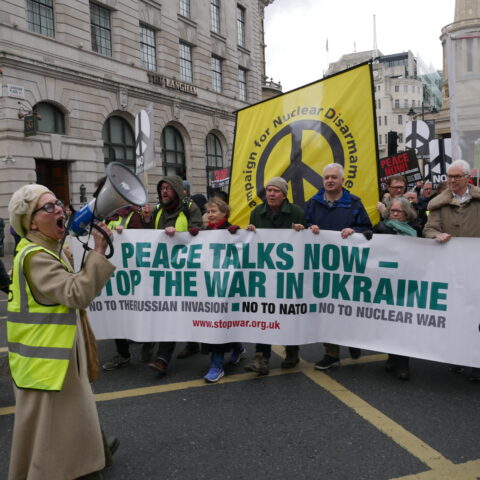 Front of march. Text on banner reads Peac talks no - stop the war in Ukraine. No to the Russian invasion. no to NATO. No to nuclear war.