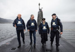 John Healey and Keir Starmer stand onto of HMS Vanguard with two Royal Navy submariners